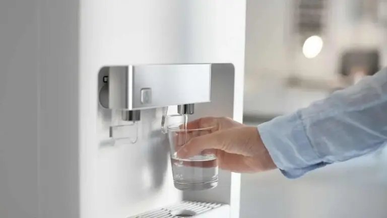 man who refills his glass with water