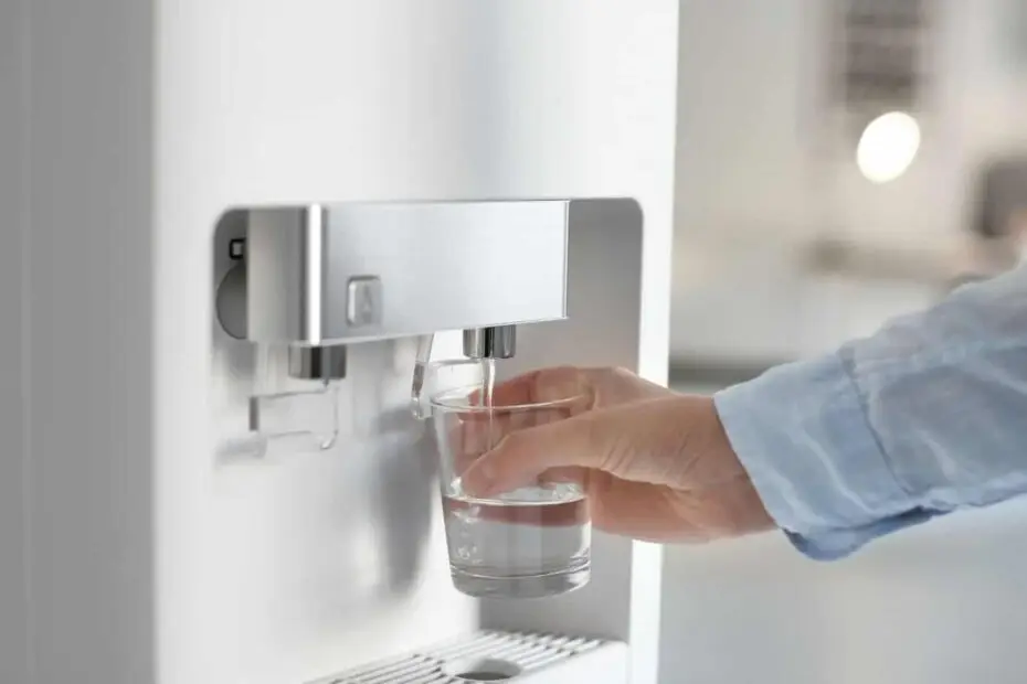 man who refills his glass with water