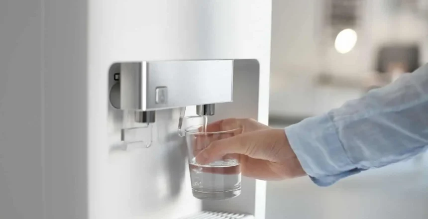 man who refills his glass with water